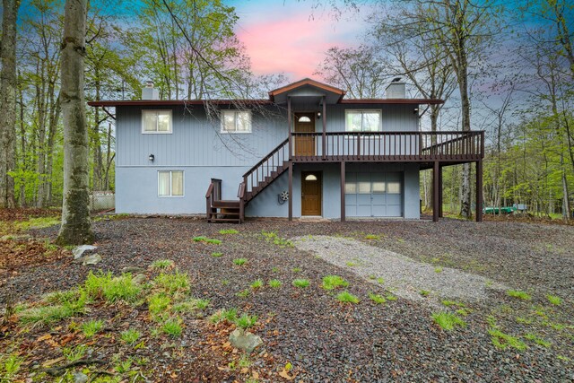 19 Conservancy Ct, Gouldsboro, PA 18424 - rear view of house featuring a chimney, stairs, driveway, and a deck