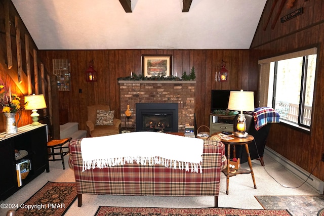 living area with a baseboard radiator, wooden walls, carpet floors, vaulted ceiling, and a brick fireplace