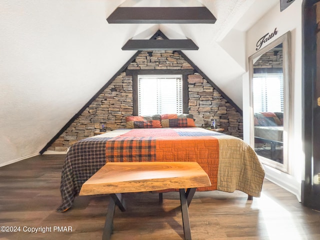 bedroom with multiple windows, lofted ceiling with beams, baseboards, and wood finished floors