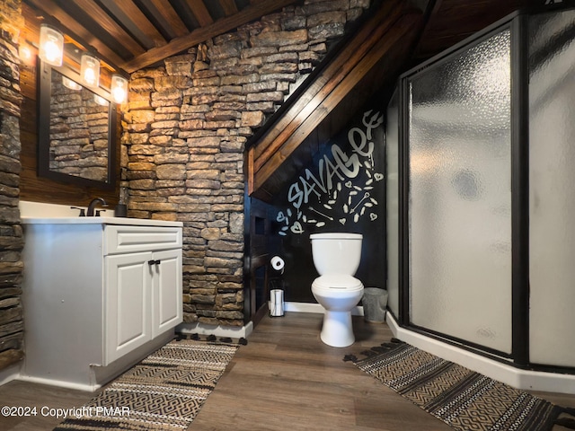 bathroom featuring a stall shower, vanity, toilet, and wood finished floors