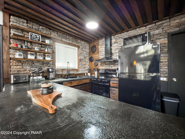 kitchen with open shelves, a sink, wall chimney range hood, black appliances, and dark countertops