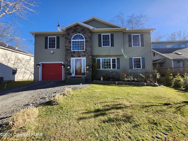 view of front of property featuring a front lawn, cooling unit, driveway, stone siding, and an attached garage