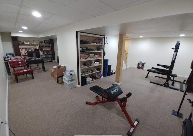 workout room with recessed lighting, a paneled ceiling, and carpet floors