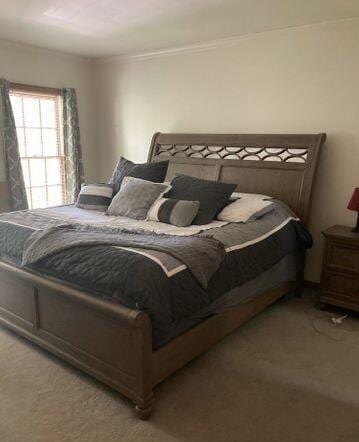 bedroom featuring light carpet