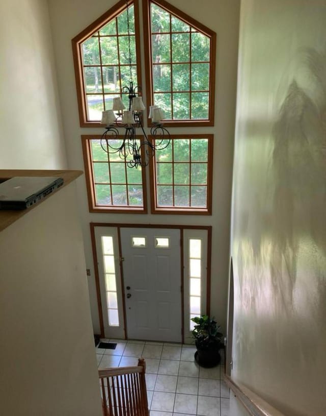 entrance foyer with a high ceiling, a notable chandelier, and a wealth of natural light