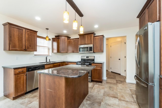 621 E Princeton Ave, Palmerton, PA 18071 - kitchen with appliances with stainless steel finishes, a sink, a kitchen island, dark stone countertops, and hanging light fixtures