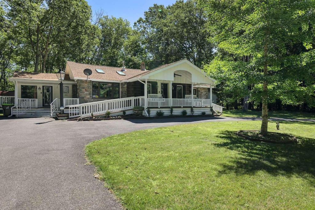 350 Lake Rd, Canadensis, PA 18325 - ranch-style home with covered porch, stone siding, and a front yard