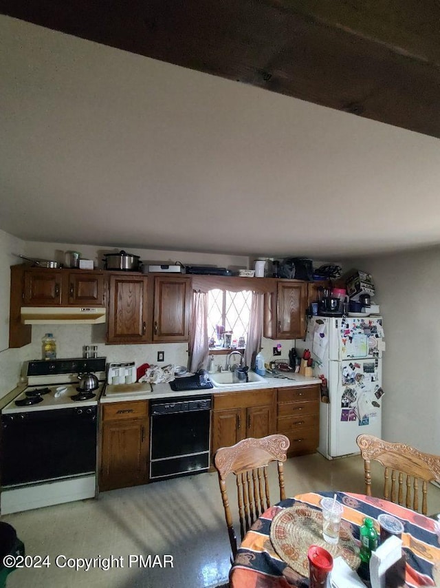 kitchen featuring range with electric cooktop, under cabinet range hood, black dishwasher, freestanding refrigerator, and a sink