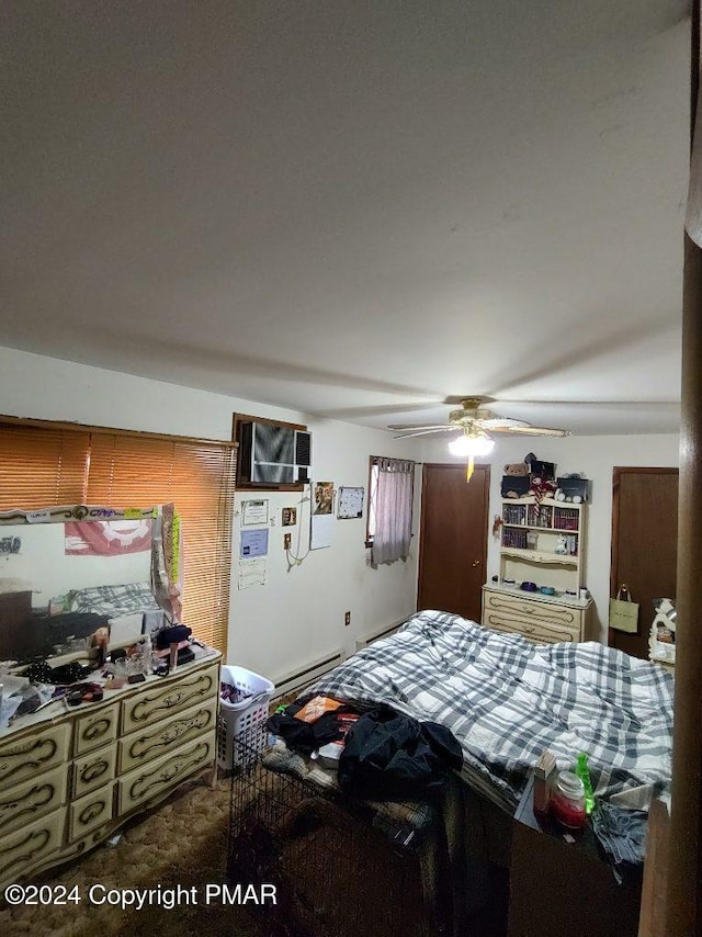 bedroom featuring a baseboard heating unit and a ceiling fan