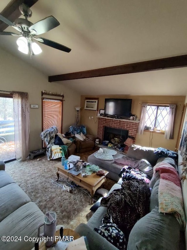 carpeted living room featuring a healthy amount of sunlight, an AC wall unit, lofted ceiling with beams, and a ceiling fan