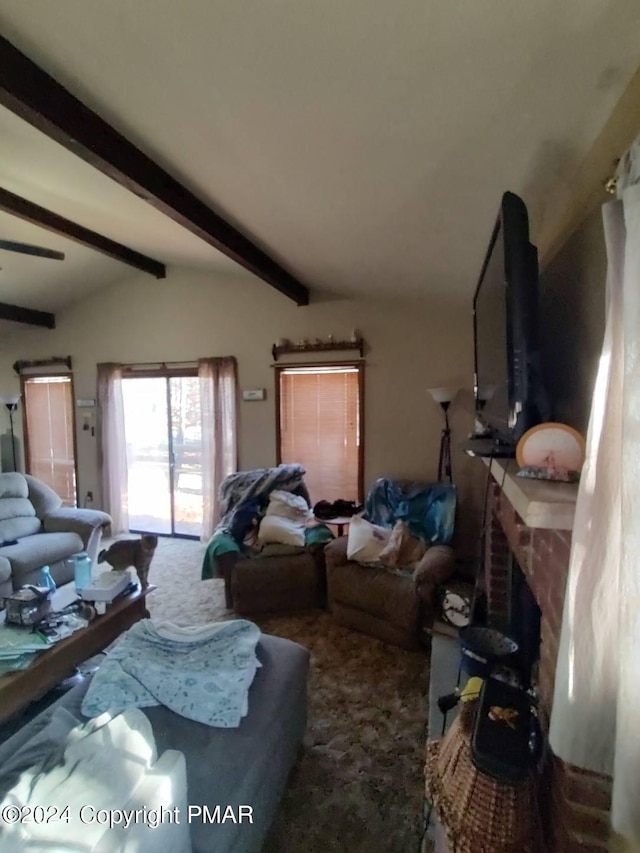 living room featuring a fireplace, lofted ceiling with beams, and carpet