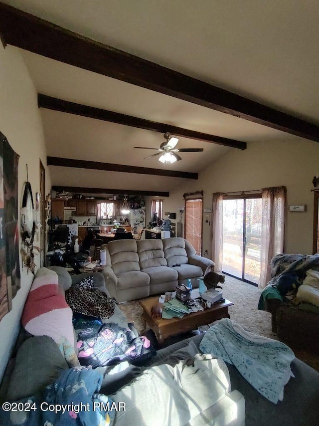 living area featuring carpet, vaulted ceiling with beams, and a ceiling fan