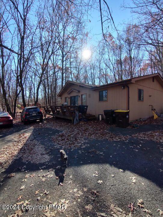 view of property exterior featuring a deck