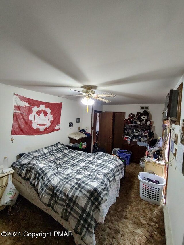 bedroom with visible vents, a ceiling fan, and carpet