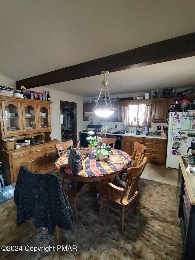 dining room featuring beamed ceiling