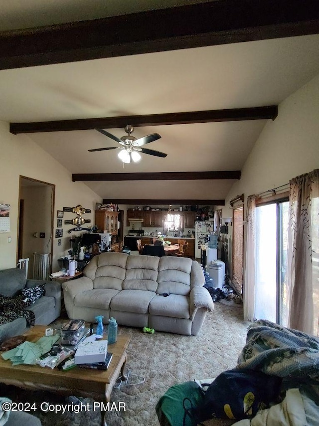 living area featuring vaulted ceiling with beams, carpet, and ceiling fan