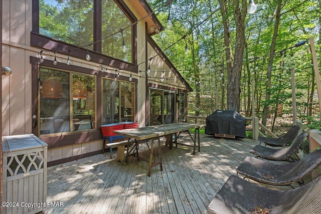 deck featuring a grill and outdoor dining space