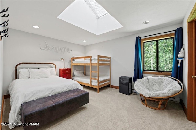 bedroom with a skylight, carpet flooring, baseboards, and recessed lighting