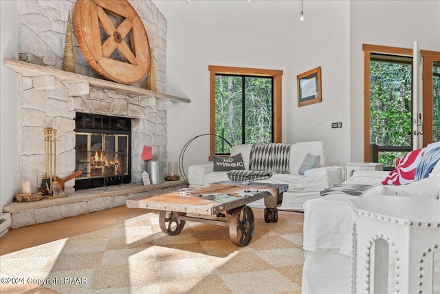 living room featuring a fireplace and a healthy amount of sunlight