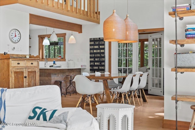 kitchen with brown cabinetry, wood finished floors, and pendant lighting