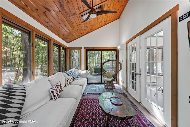 sunroom / solarium with wood ceiling, vaulted ceiling, a ceiling fan, and french doors