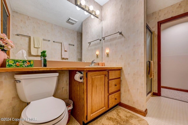 full bathroom featuring visible vents, toilet, a stall shower, baseboards, and vanity