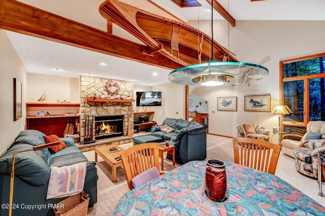 dining room featuring high vaulted ceiling, beam ceiling, carpet, and a fireplace