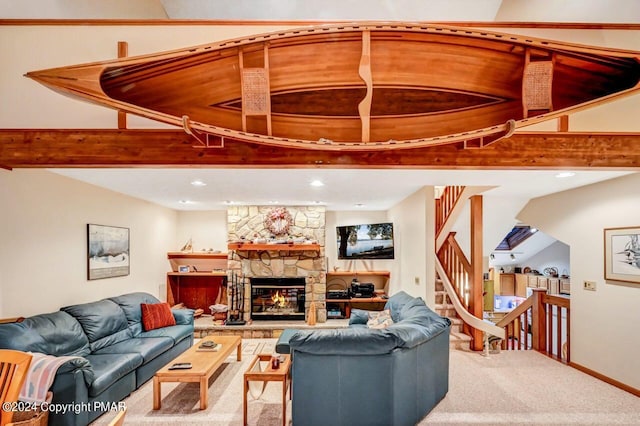 carpeted living area with a stone fireplace, beam ceiling, stairs, and baseboards