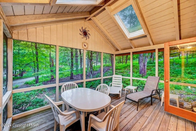 sunroom with vaulted ceiling with skylight and wood ceiling