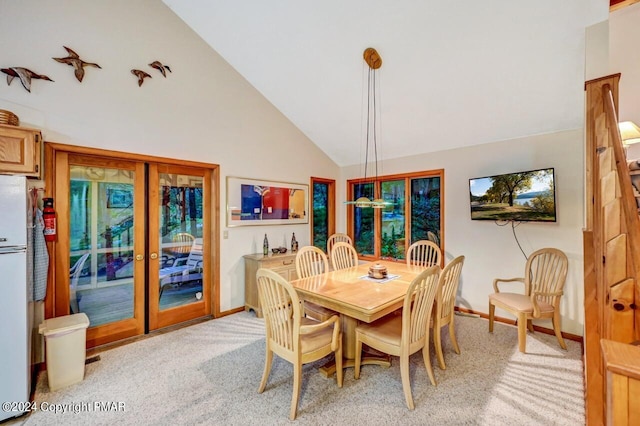 dining area featuring high vaulted ceiling, french doors, baseboards, and light carpet