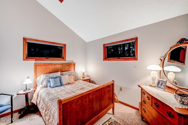 bedroom featuring light carpet, baseboards, and vaulted ceiling