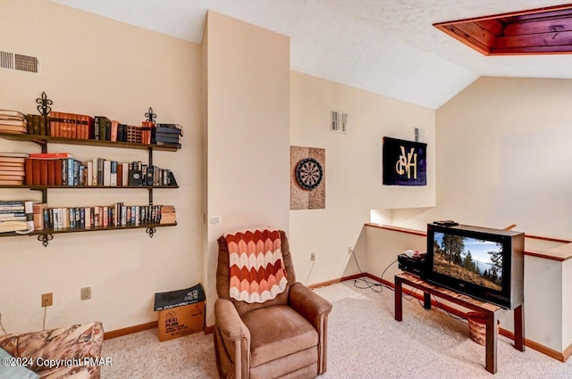 sitting room featuring visible vents, baseboards, carpet, and vaulted ceiling