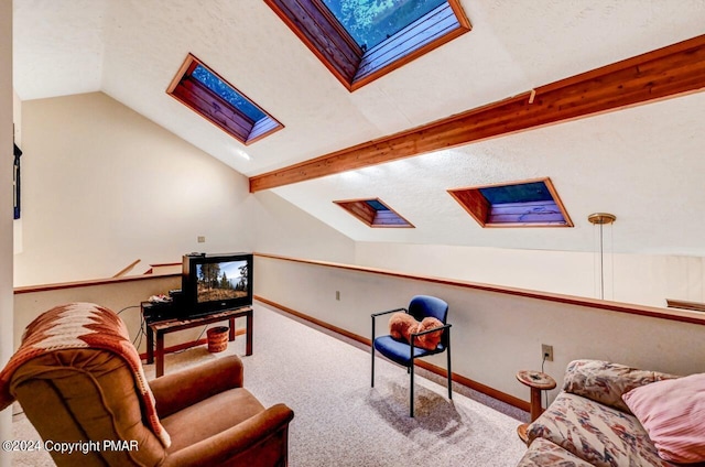 living area with vaulted ceiling with skylight, carpet, baseboards, and a textured ceiling