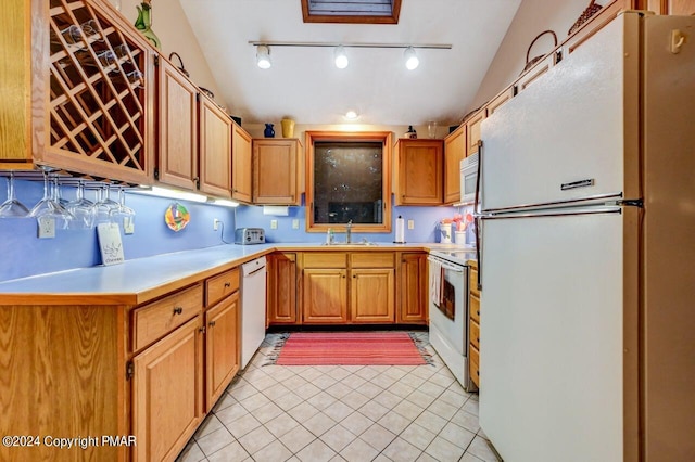 kitchen featuring light tile patterned floors, white appliances, a sink, and light countertops