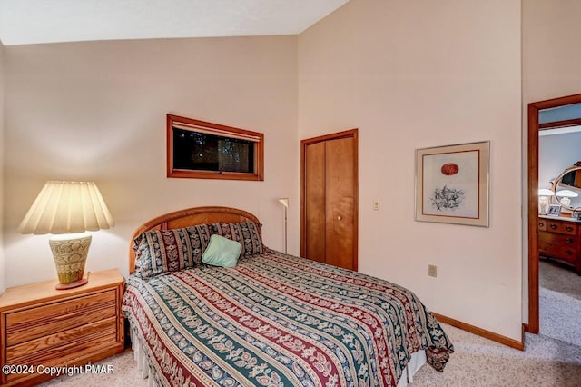 carpeted bedroom featuring baseboards and vaulted ceiling