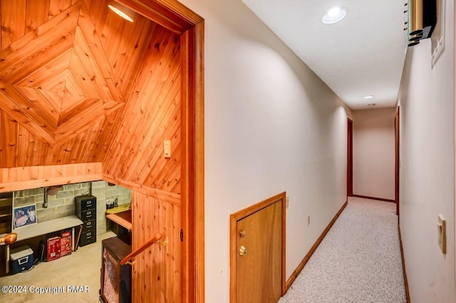 hallway featuring carpet and baseboards