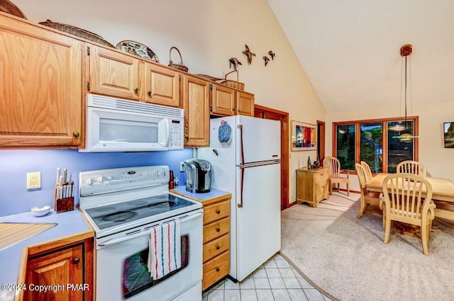 kitchen featuring white appliances, light tile patterned flooring, light countertops, pendant lighting, and light carpet