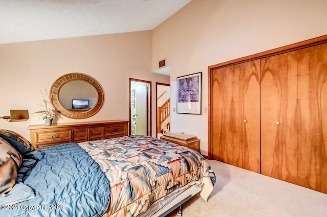 bedroom featuring a closet, carpet flooring, visible vents, and vaulted ceiling