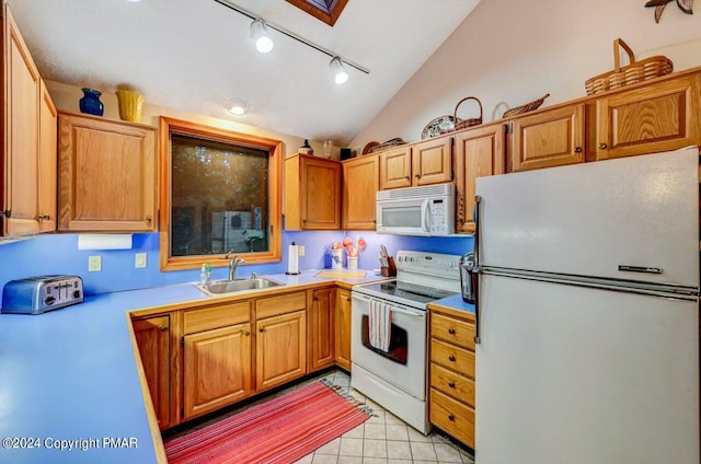 kitchen with a sink, white appliances, light countertops, light tile patterned floors, and vaulted ceiling