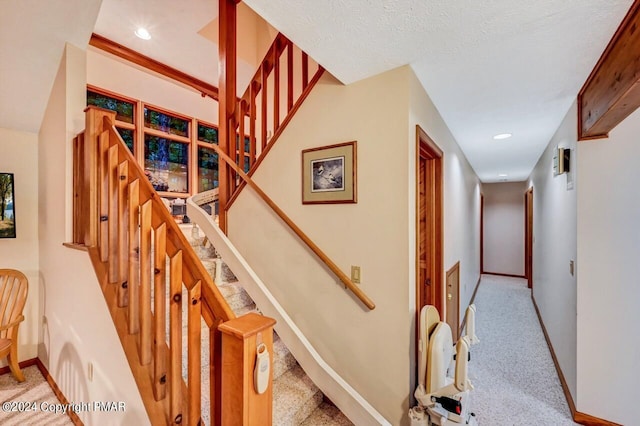 stairs featuring carpet flooring, recessed lighting, baseboards, and a textured ceiling