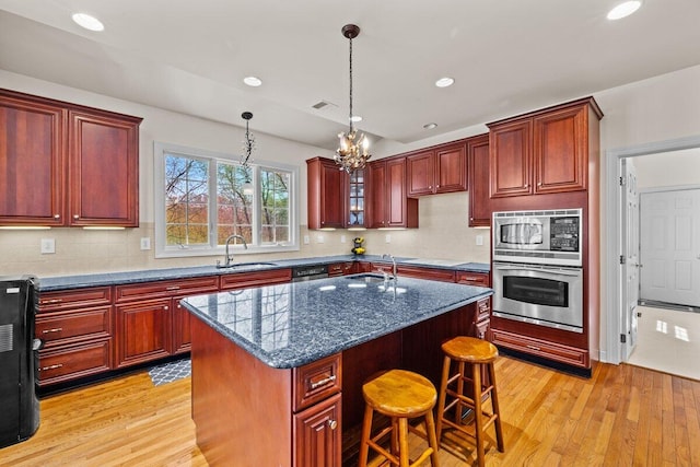 kitchen featuring a sink, stainless steel appliances, and dark brown cabinets