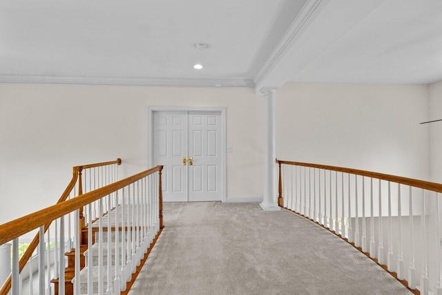 hallway featuring ornamental molding, baseboards, recessed lighting, carpet flooring, and an upstairs landing