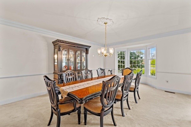 dining space with visible vents, ornamental molding, a chandelier, and light colored carpet