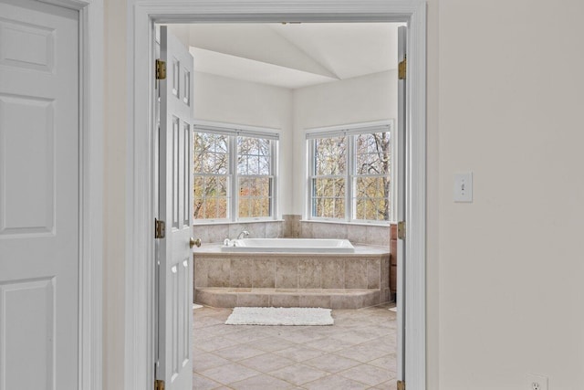 full bath featuring tile patterned flooring and a bath