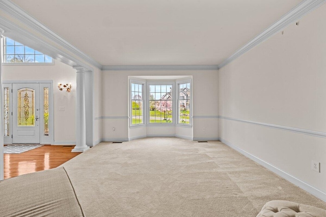 interior space featuring crown molding, decorative columns, and a wealth of natural light