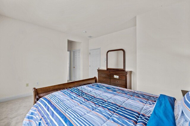 bedroom with baseboards and carpet flooring