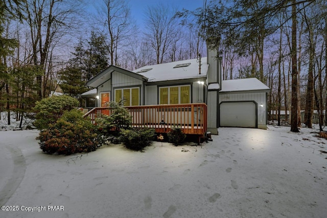 view of front of house with a deck and an attached garage