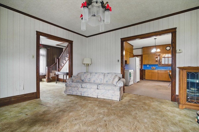 639 Iron St, Lehighton, PA 18235 - living area with ornamental molding, light carpet, stairs, a chandelier, and a textured ceiling