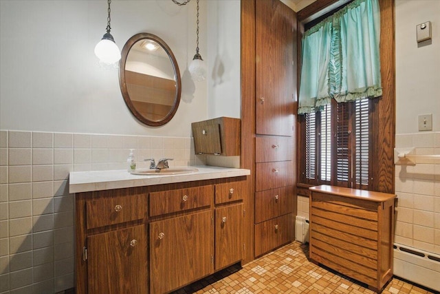 639 Iron St, Lehighton, PA 18235 - bathroom featuring tile walls, vanity, and a wainscoted wall