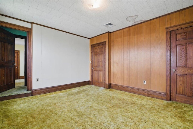 639 Iron St, Lehighton, PA 18235 - spare room featuring carpet floors, ornamental molding, and wooden walls